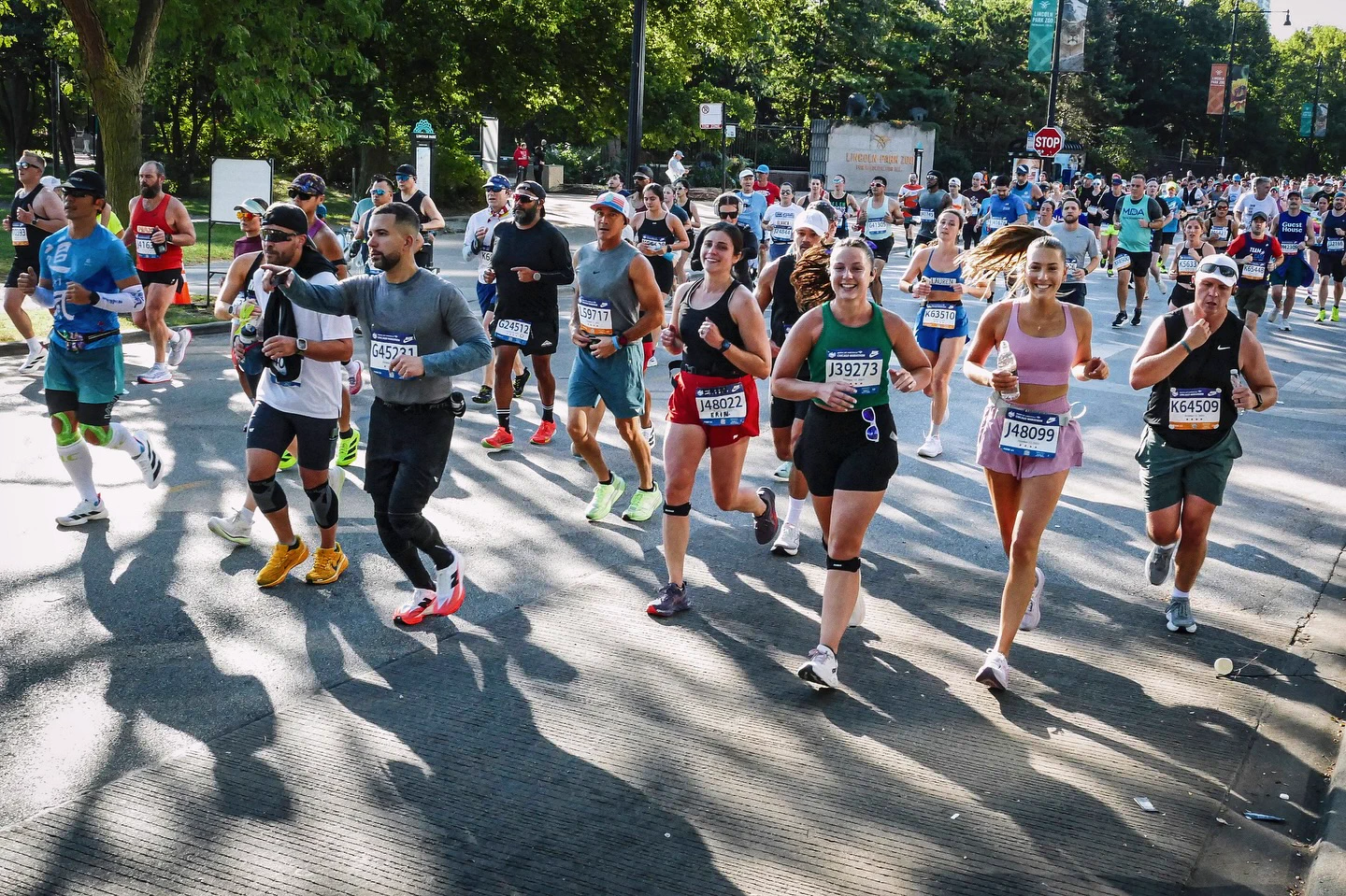 Lindi in pink running with a pack through Lincoln Park during the Chicago Marathon